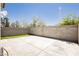 Large concrete backyard patio area with an area of artificial turf surrounded by a block wall at 795 Kiska Ave, Las Vegas, NV 89123
