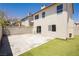 Backyard with a concrete patio and artificial turf, complemented by a wall that ensures privacy and security at 795 Kiska Ave, Las Vegas, NV 89123