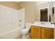 Bright bathroom featuring a tub-shower combo and a vanity with a sink and wooden cabinets at 795 Kiska Ave, Las Vegas, NV 89123