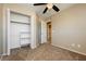 Bedroom featuring plush carpeting, ample closet space, an ensuite bathroom, and ceiling fan at 795 Kiska Ave, Las Vegas, NV 89123