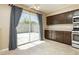 Kitchen area with slider doors to patio and plenty of cabinet storage at 795 Kiska Ave, Las Vegas, NV 89123
