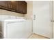 Well-equipped laundry room with a washer and dryer set and overhead cabinets for ample storage at 795 Kiska Ave, Las Vegas, NV 89123