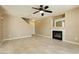 Spacious living room featuring tile floors, a ceiling fan, and a modern fireplace at 795 Kiska Ave, Las Vegas, NV 89123
