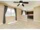 Living room with tile floors, ceiling fan, and an open view into the kitchen area at 795 Kiska Ave, Las Vegas, NV 89123