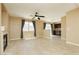 Open living room featuring tile floors, neutral walls, fireplace, and lots of natural light at 795 Kiska Ave, Las Vegas, NV 89123