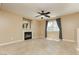 Cozy living room with fireplace, ceiling fan, and natural light from a large window at 795 Kiska Ave, Las Vegas, NV 89123