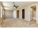 Large main bedroom featuring an ensuite bathroom, closet, ceiling fan and plush carpeting at 795 Kiska Ave, Las Vegas, NV 89123