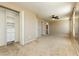 Main bedroom featuring an ensuite bathroom, walk-in closet, ceiling fan, and plush carpeting at 795 Kiska Ave, Las Vegas, NV 89123