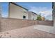 An enclosed backyard features gravel and paver stone details; the house is finished with modern stucco at 8056 Haywood Estate Ave, Las Vegas, NV 89113