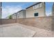 Paver patio surrounded by brick walls and desert landscaping in the backyard at 8056 Haywood Estate Ave, Las Vegas, NV 89113