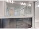 Modern bathroom featuring double sinks, sleek cabinets, and large vanity mirror at 8056 Haywood Estate Ave, Las Vegas, NV 89113