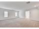 Open bedroom with neutral carpeting, crisp white walls, and bright natural light at 8056 Haywood Estate Ave, Las Vegas, NV 89113