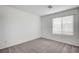 Comfortable bedroom featuring a window with horizontal blinds and light-colored carpet at 8056 Haywood Estate Ave, Las Vegas, NV 89113