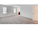 Bright bedroom with two windows and neutral carpet, located next to an en suite bathroom at 8056 Haywood Estate Ave, Las Vegas, NV 89113