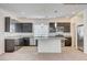 Modern kitchen features dark cabinets, stainless appliances, and a center island with granite countertops at 8056 Haywood Estate Ave, Las Vegas, NV 89113