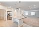 Open concept kitchen with center island, granite countertops, stainless steel refrigerator, and tile floors at 8056 Haywood Estate Ave, Las Vegas, NV 89113