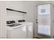 Bright laundry area with full-size washer and dryer, and an exterior door with window at 8056 Haywood Estate Ave, Las Vegas, NV 89113