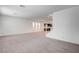 Expansive living space with neutral carpet, recessed lighting, and kitchen view at 8056 Haywood Estate Ave, Las Vegas, NV 89113