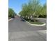 Paved neighborhood entrance showcases manicured landscaping and mature trees at 8056 Haywood Estate Ave, Las Vegas, NV 89113
