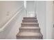 Stairway with carpeted steps and white banister leading to upper level at 8056 Haywood Estate Ave, Las Vegas, NV 89113