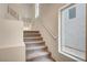 Carpeted stairs with white walls and a side window leading to upper floors at 8056 Haywood Estate Ave, Las Vegas, NV 89113