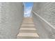 Exterior staircase featuring textured walls and metal banister at 8056 Haywood Estate Ave, Las Vegas, NV 89113