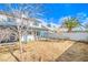 View of the home's backyard featuring a covered patio, fence, and palm tree at 824 Schooner Dr, Henderson, NV 89015