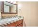 Bathroom vanity featuring granite countertop, modern fixtures, and a decorative mirror at 824 Schooner Dr, Henderson, NV 89015