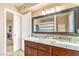 Double vanity bathroom featuring granite countertops, modern fixtures, and decorative mirror at 824 Schooner Dr, Henderson, NV 89015