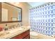 Stylish bathroom featuring a modern vanity with a marble countertop and a shower with a blue geometric curtain at 824 Schooner Dr, Henderson, NV 89015