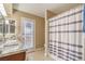 Updated bathroom featuring double sinks, granite countertop, shower and outside access at 824 Schooner Dr, Henderson, NV 89015