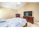 Bedroom featuring a classic bed, coordinating wooden dressers, and a flatscreen television at 824 Schooner Dr, Henderson, NV 89015