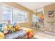 Sunlit bedroom with a large window, mirrored closet, and playful decor creating a cheerful atmosphere at 824 Schooner Dr, Henderson, NV 89015
