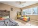 Cozy bedroom featuring two twin beds, a ceiling fan, and a window providing ample natural light at 824 Schooner Dr, Henderson, NV 89015