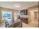 Open dining area with dark wood furniture, tile floors and built in hutch with glass display at 824 Schooner Dr, Henderson, NV 89015