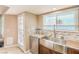 Stainless steel farmhouse sink, granite counters, updated kitchen with backyard access door at 824 Schooner Dr, Henderson, NV 89015