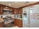 Updated kitchen with stainless steel appliances, granite countertops and dark wood cabinetry at 824 Schooner Dr, Henderson, NV 89015