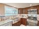 Stainless steel farmhouse sink with granite countertops and dark wood cabinets in the remodeled kitchen at 824 Schooner Dr, Henderson, NV 89015