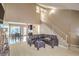 Bright, spacious living room with staircase, seamlessly connected to the adjacent dining area at 824 Schooner Dr, Henderson, NV 89015