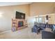 Comfortable living room featuring a fireplace, TV, and cozy seating in an open-concept space at 824 Schooner Dr, Henderson, NV 89015