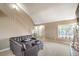 Open floor plan living room with staircase, cozy furniture, and natural light at 824 Schooner Dr, Henderson, NV 89015