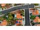 This aerial view shows a home with an inground pool in a community filled with mature trees and sidewalks at 8388 Brad Oaks Cir, Las Vegas, NV 89123