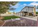 Expansive backyard with a covered patio, lounge chairs, and a seating area on a brick-paved terrace at 8388 Brad Oaks Cir, Las Vegas, NV 89123