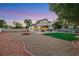 Large backyard featuring a covered patio, green lawn, and drought-tolerant landscaping for easy maintenance at 8388 Brad Oaks Cir, Las Vegas, NV 89123