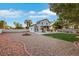 Expansive backyard with low maintenance landscaping, covered patio, and space for outdoor activities at 8388 Brad Oaks Cir, Las Vegas, NV 89123