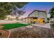 Inviting backyard with a covered patio, outdoor seating, and a beautifully landscaped brick-paved terrace at 8388 Brad Oaks Cir, Las Vegas, NV 89123