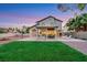 Spacious backyard with a covered patio, lush lawn, and ample space for recreation and relaxation at 8388 Brad Oaks Cir, Las Vegas, NV 89123