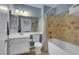 Bathroom featuring tiled shower over tub and a large vanity at 8388 Brad Oaks Cir, Las Vegas, NV 89123