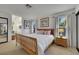 Bright bedroom with a wooden bed frame, neutral walls, and large windows for plenty of natural light at 8388 Brad Oaks Cir, Las Vegas, NV 89123
