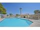 Inviting community pool area with blue water, lounge chairs, and shade structures at 8388 Brad Oaks Cir, Las Vegas, NV 89123
